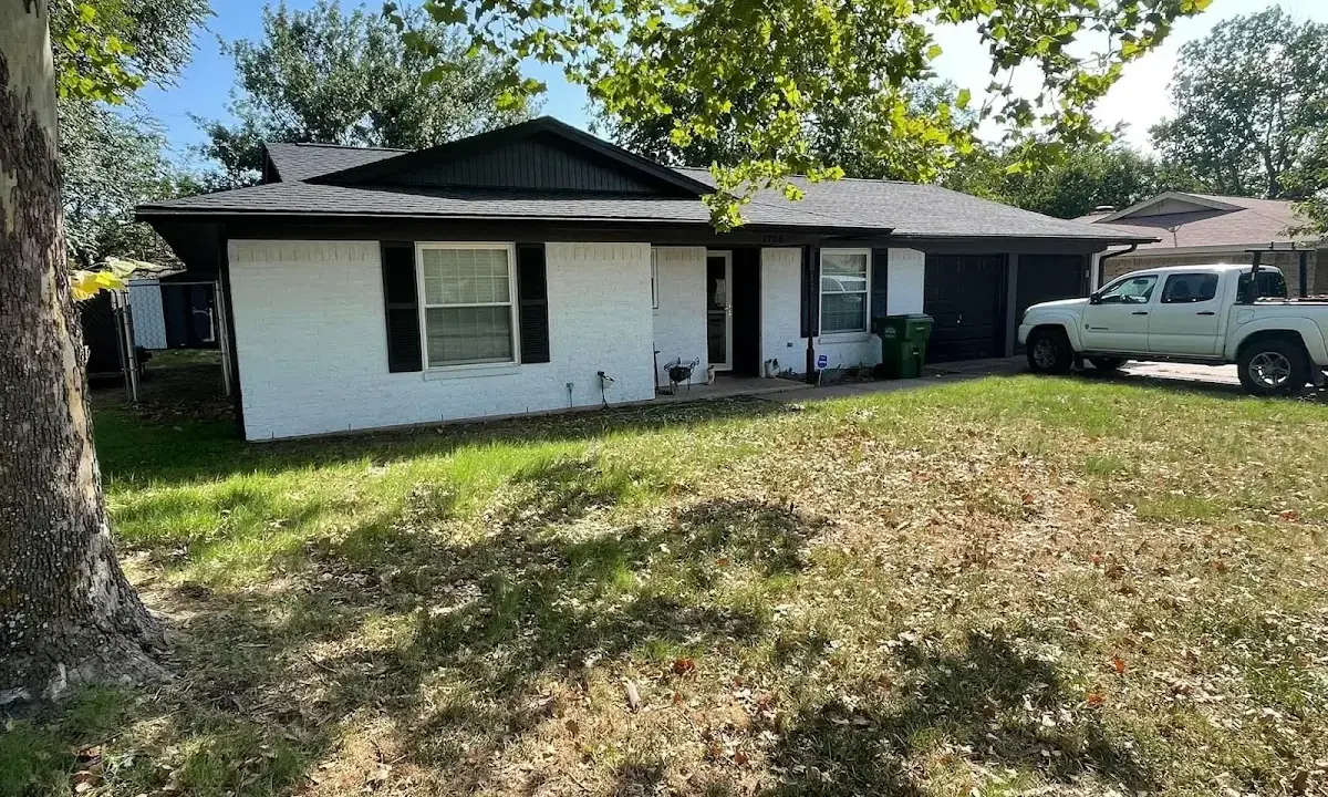 Professional roofing crew working on a residential roof in Wake Village